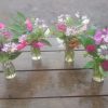 4 beautiful little posies in vintage milk bottle style vases