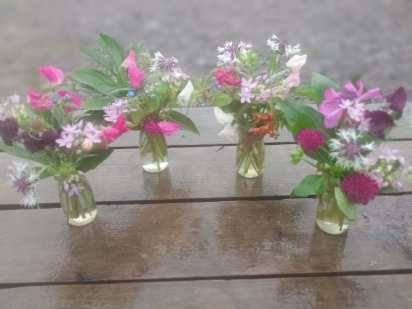 4 beautiful little posies in vintage milk bottle style vases